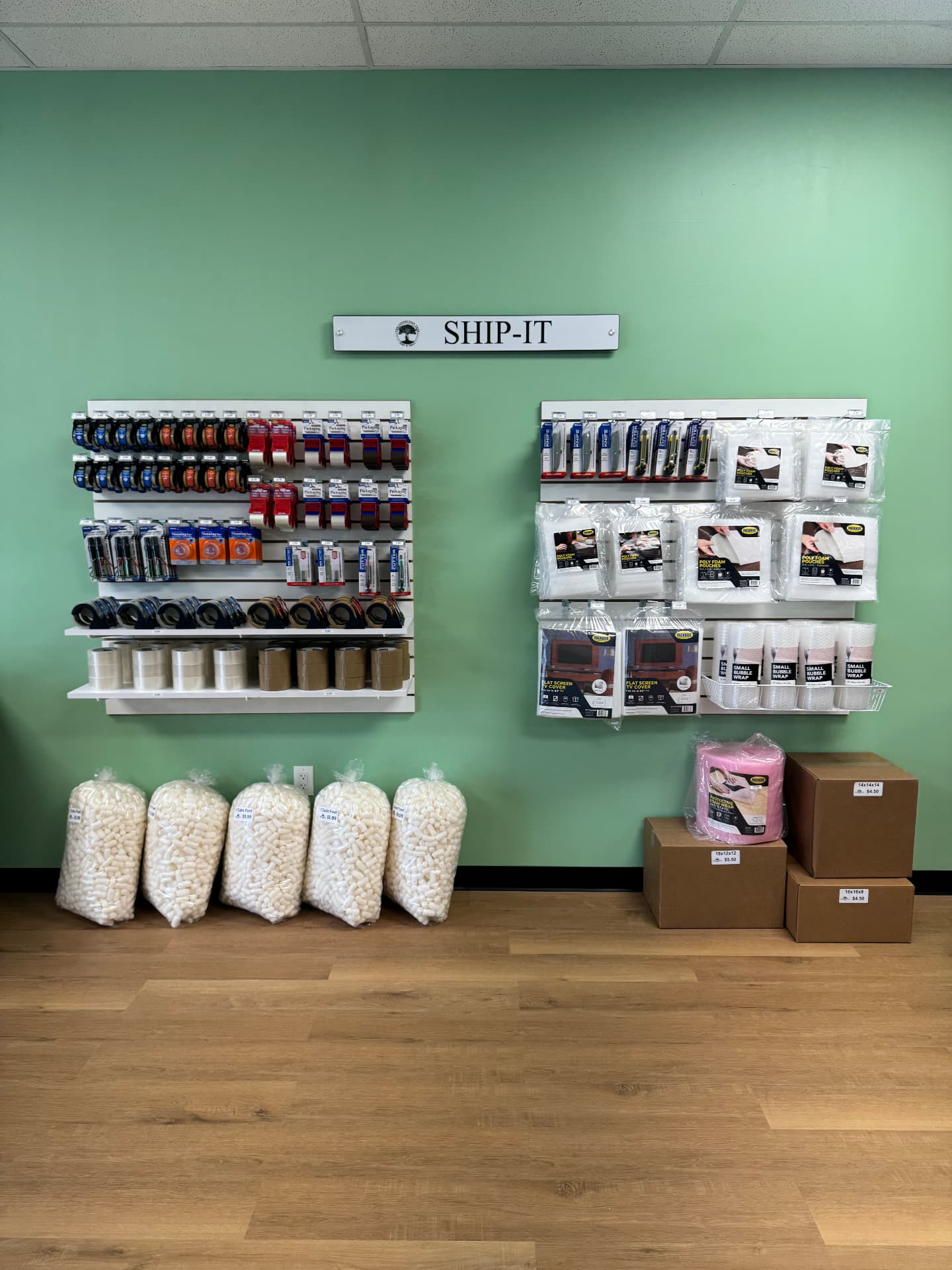 Ship-It wall with boxes, tape and packing supplies