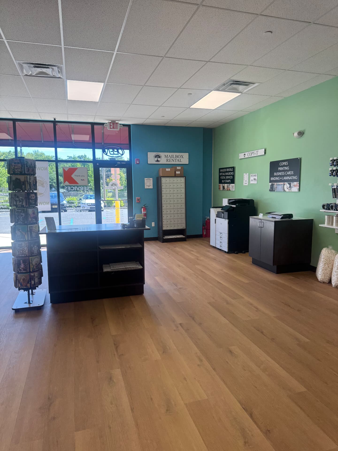 Front lobby with the mailbox rental wall and copy station at The Connection Tree Ship and Print in Freehold, New Jersey