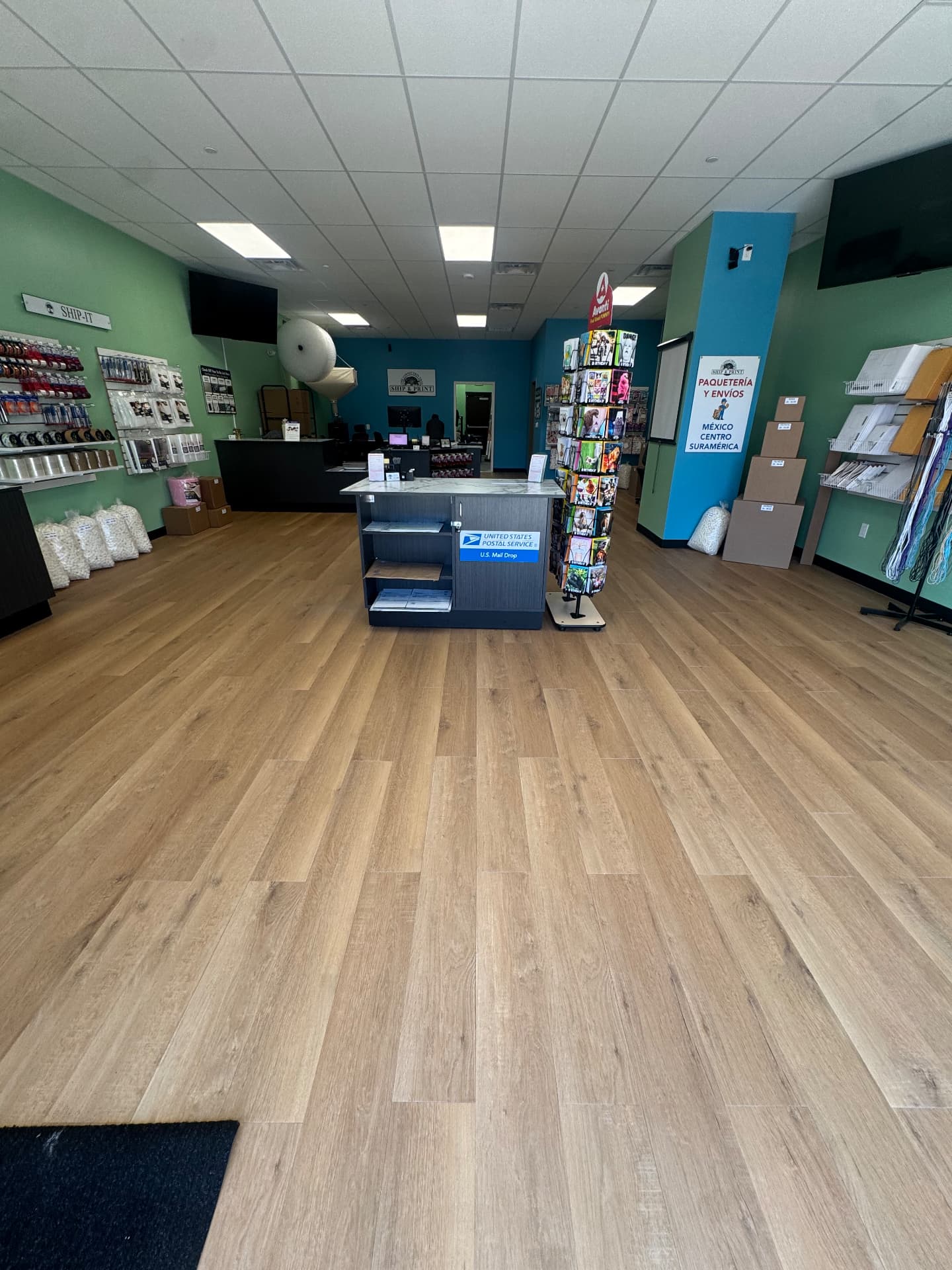 Sales floor with the U.S. mail drop and the paquetería y envíos sign at The Connection Tree Ship and Print in Freehold, New Jersey